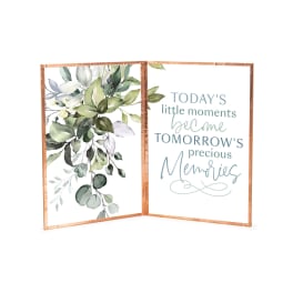 Folded framed sign with watercolor leaves and a quote about memories