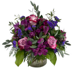 Purple and pink rose bouquet in a glass vase