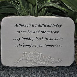 Stone memorial plaque with a sympathy quote and carved floral design