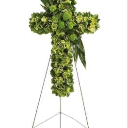 Green floral cross on a metal easel