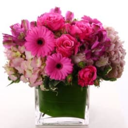 Pink mixed bouquet in a clear square vase