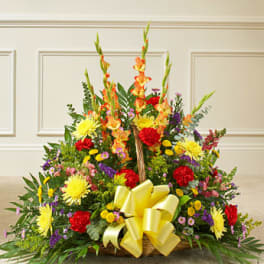 Large mixed flower basket with a yellow ribbon
