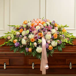 Large floral casket spray with pink, orange, and white blooms