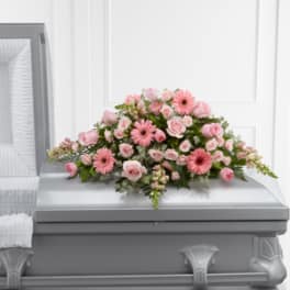 Pink floral casket spray with roses and gerbera daisies