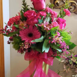 Pink rose and gerbera bouquet with a bright ribbon on a stand