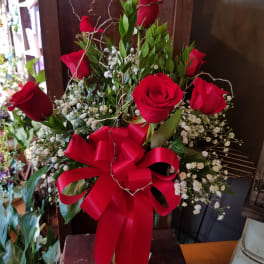 Red roses with baby's breath and a large red ribbon