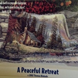 Fringed throw blanket with a cabin and forest scene and Bible verse text