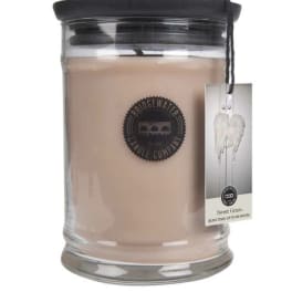 Glass jar candle with black lid and hanging tag