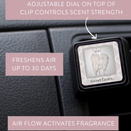 Car air freshener clip labeled Sweet Grace on a dashboard vent