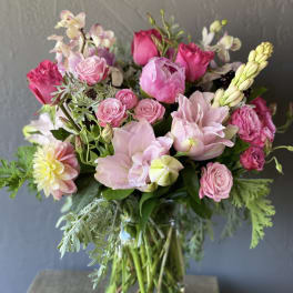 Pink and blush mixed bouquet in a clear glass vase