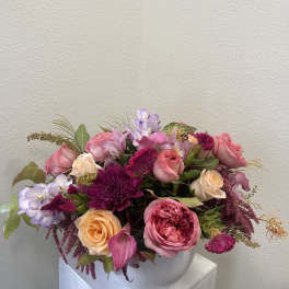 Pink and lavender mixed bouquet in a white vase