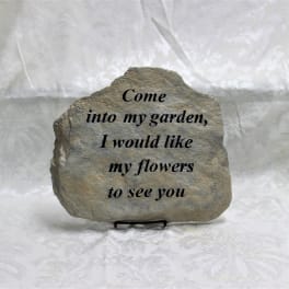 Engraved stone plaque with a garden quote on a stand