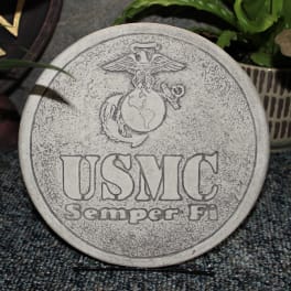 Round stone plaque engraved with the USMC emblem and text