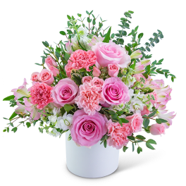 Pink roses and carnations in a white vase