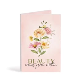 Pink greeting card with watercolor flowers and the words "beauty comes from within"