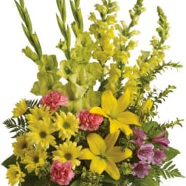 Tall basket arrangement with yellow lilies, daisies, snapdragons and pink mixed flowers