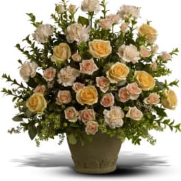 Large bouquet of pale roses and carnations in a vase