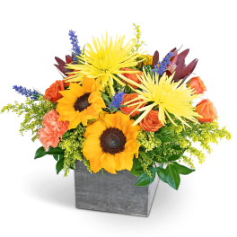Bouquet of sunflowers and orange roses in a gray square vase