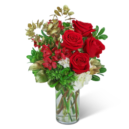 Red roses and red alstroemeria in a clear glass vase