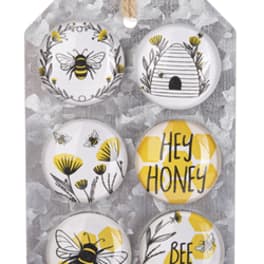Set of six bee-themed decorative magnets on a hanging board