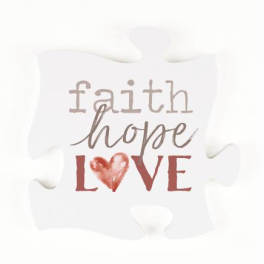 White decorative pillow with the words faith hope love