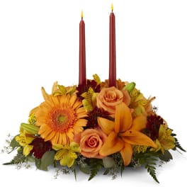 Autumn floral centerpiece with two red taper candles