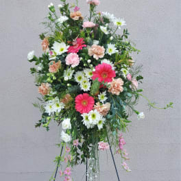 Tall floral standing spray with pink, white, and peach blooms