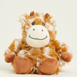Plush giraffe toy with brown and white fur sitting on a plain background