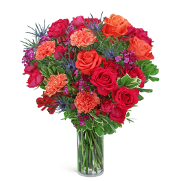Mixed bouquet of red and orange roses in a clear glass vase
