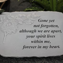 Memorial stone with engraved flower and remembrance text