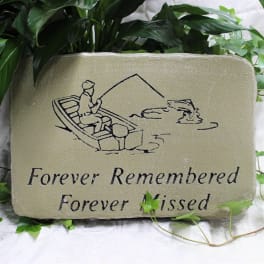 Memorial stone with a fishing scene and the words Forever Remembered Forever Missed
