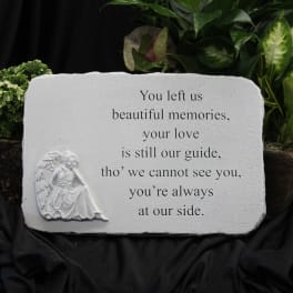 Memorial stone with an angel relief and engraved sympathy message