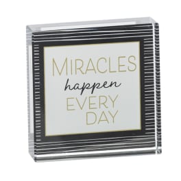 Decorative sign with the words "Miracles happen every day"