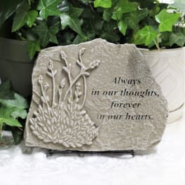 Memorial stone with floral relief and the words "Always in our thoughts, forever in our hearts."