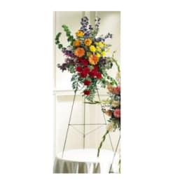 Tall floral arrangement on a metal stand with multicolored blooms
