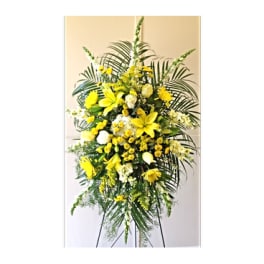 Tall yellow floral standing spray on a black easel