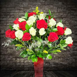 Bouquet of red and white roses in a red vase