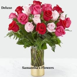 Bouquet of red, pink, and white roses in a glass vase
