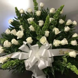 Large white rose arrangement with a silver ribbon bow