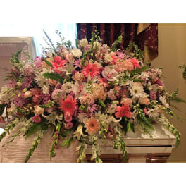 Large pastel floral casket spray with pink and white blooms