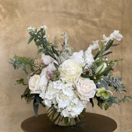 White rose and hydrangea arrangement in a glass vase