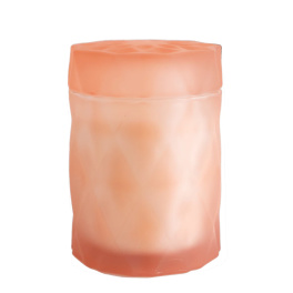 Peach-colored cylindrical candle in a frosted container