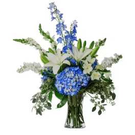 Blue and white floral arrangement in a clear glass vase