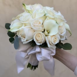 White rose and calla lily bouquet with a satin ribbon