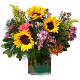 Sunflowers and pink roses in a glass vase