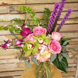 Pink roses and orchids in a glass vase