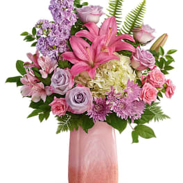 Pink and lavender bouquet with lilies, roses, and hydrangea in a pink vase