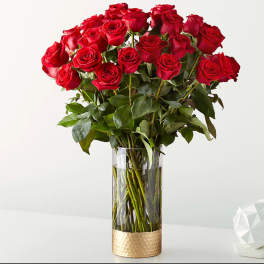 Bouquet of red roses in a tall clear vase