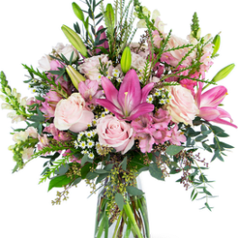 Tall pink and white bouquet with lilies and roses in a clear glass vase