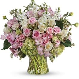 Pink and white mixed flower bouquet in a glass vase